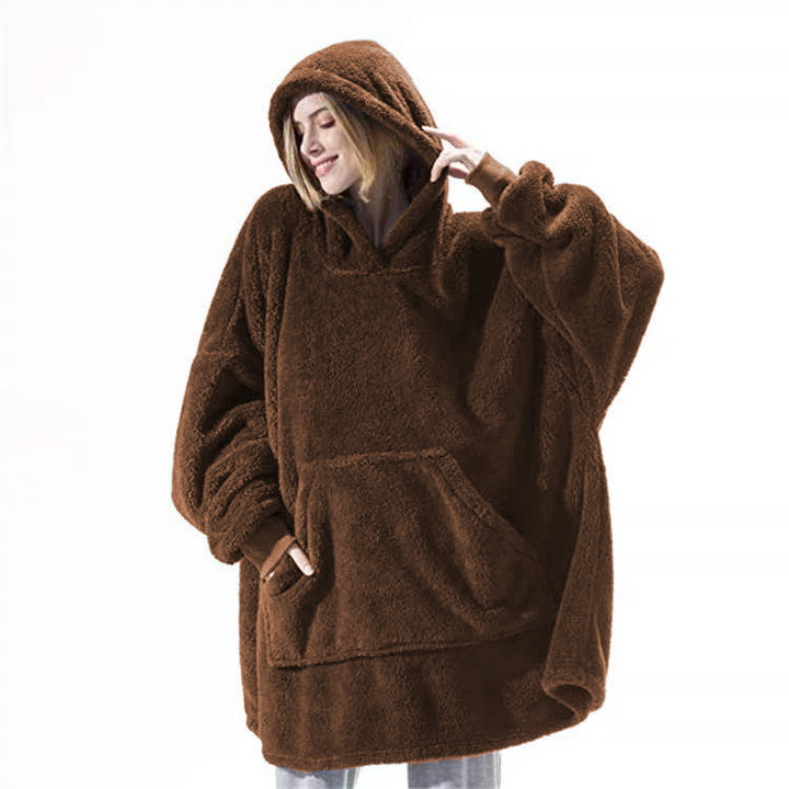 Person relaxing in an oversized blanket hoodie