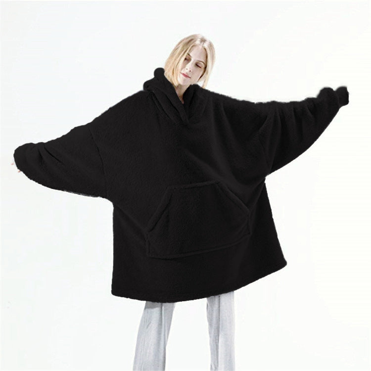 Person relaxing in an oversized blanket hoodie