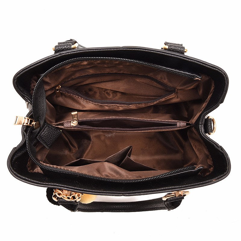 Embossed top handle handbag with pompom