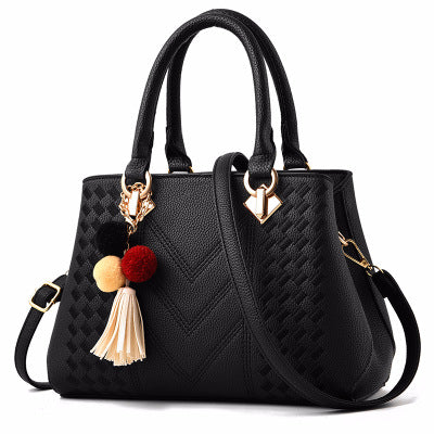 Embossed top handle handbag with pompom