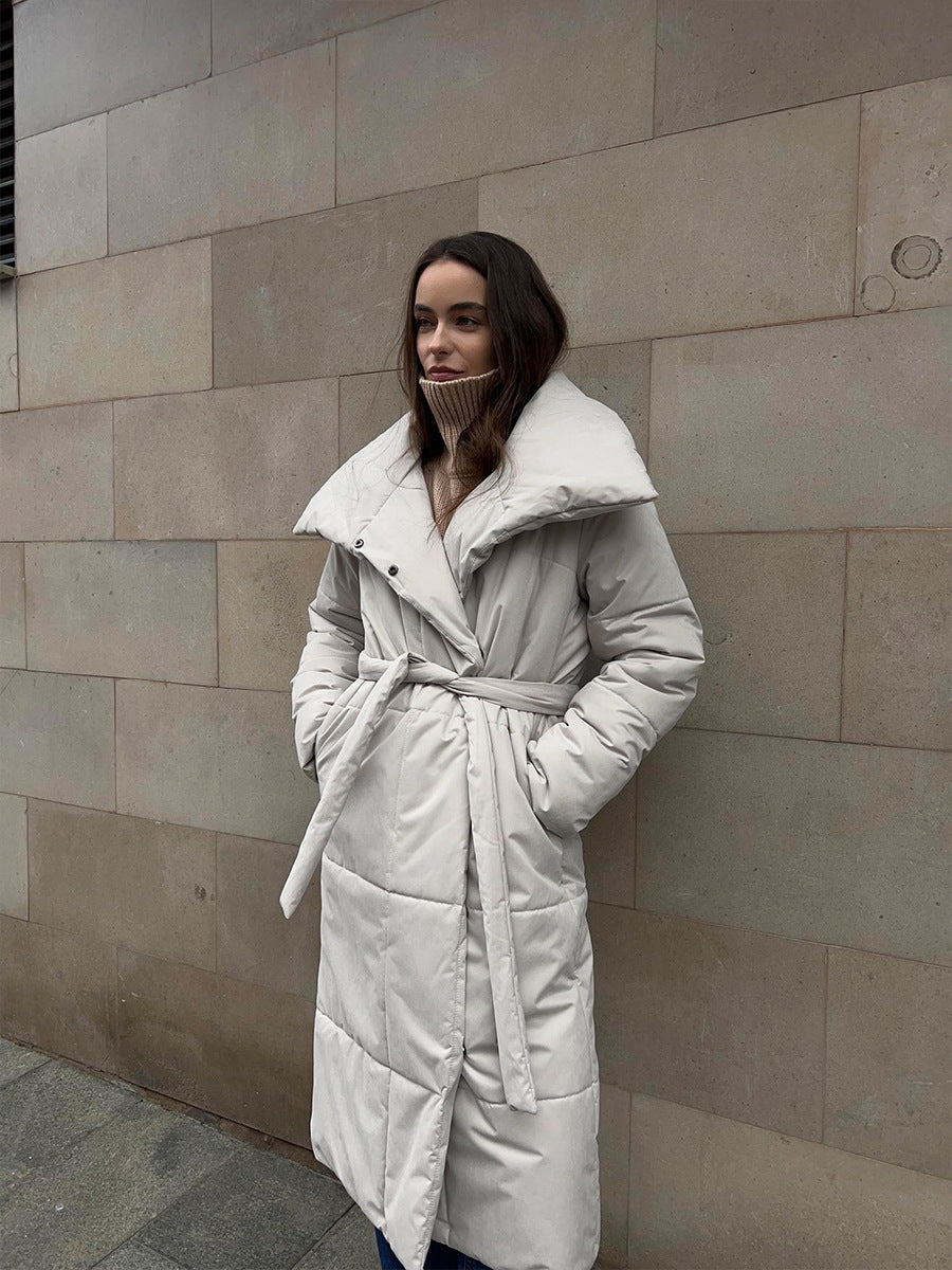 Woman in a long quilted coat with belt
