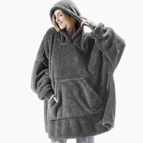 Person relaxing in an oversized blanket hoodie