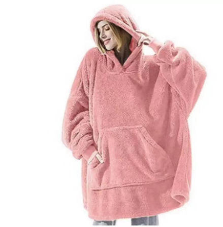 Person relaxing in an oversized blanket hoodie